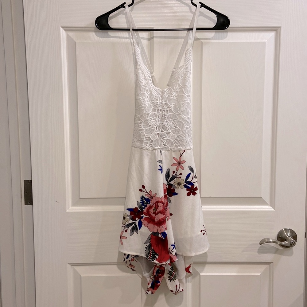 White backless romper with pink, burgundy, and navy flowers. Size Small